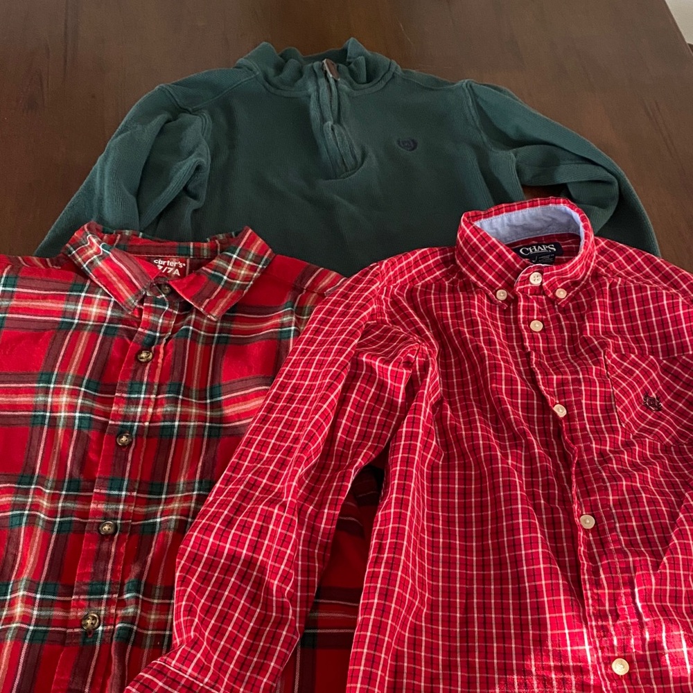 Two button down shirts and one pullover sweater.